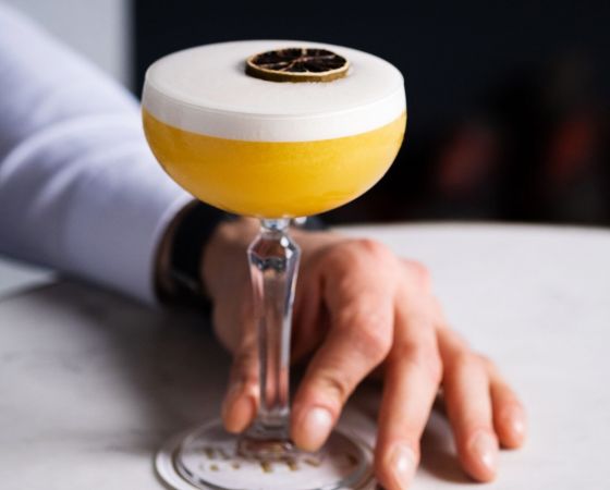 A Passionata, Café en Seine's take on the passion fruit martini cocktail served with a passion fruit slice garnish